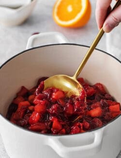 cranberry sauce with apple and orange, in a white pot