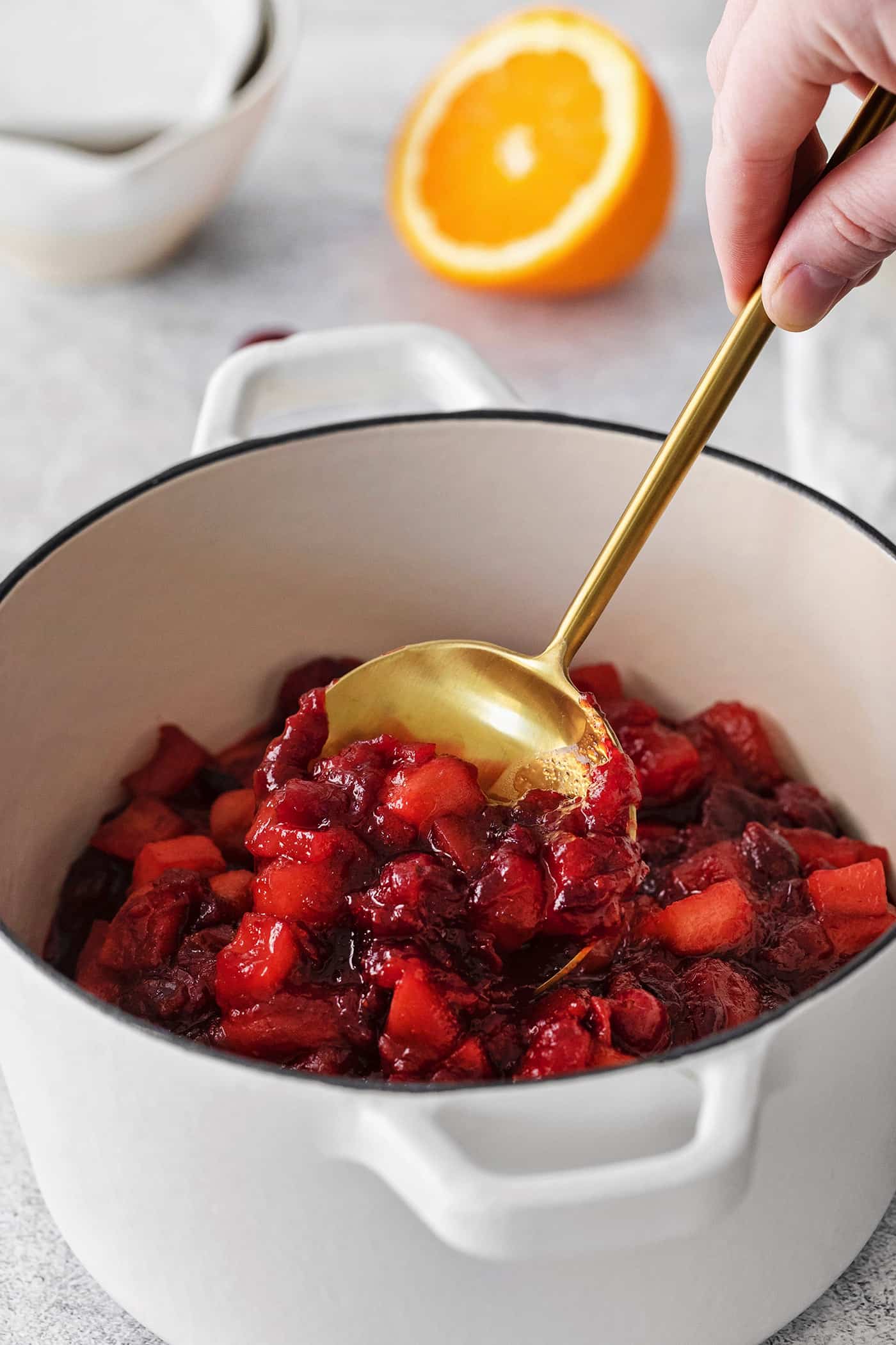 cranberry sauce with apple and orange, in a white pot