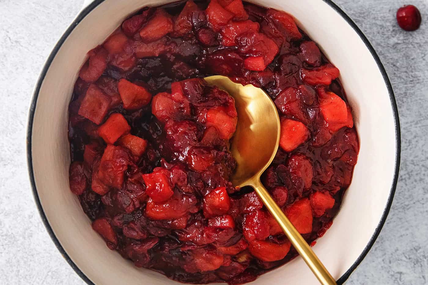 cranberry sauce with apple and orange, in a white pot