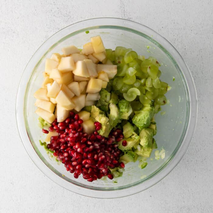 Avocado, pomegranate seeds, and pears in a bowl