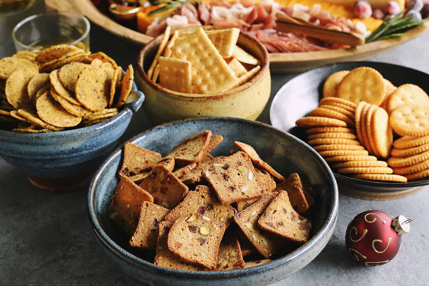 a variety of crackers in pottery bowls