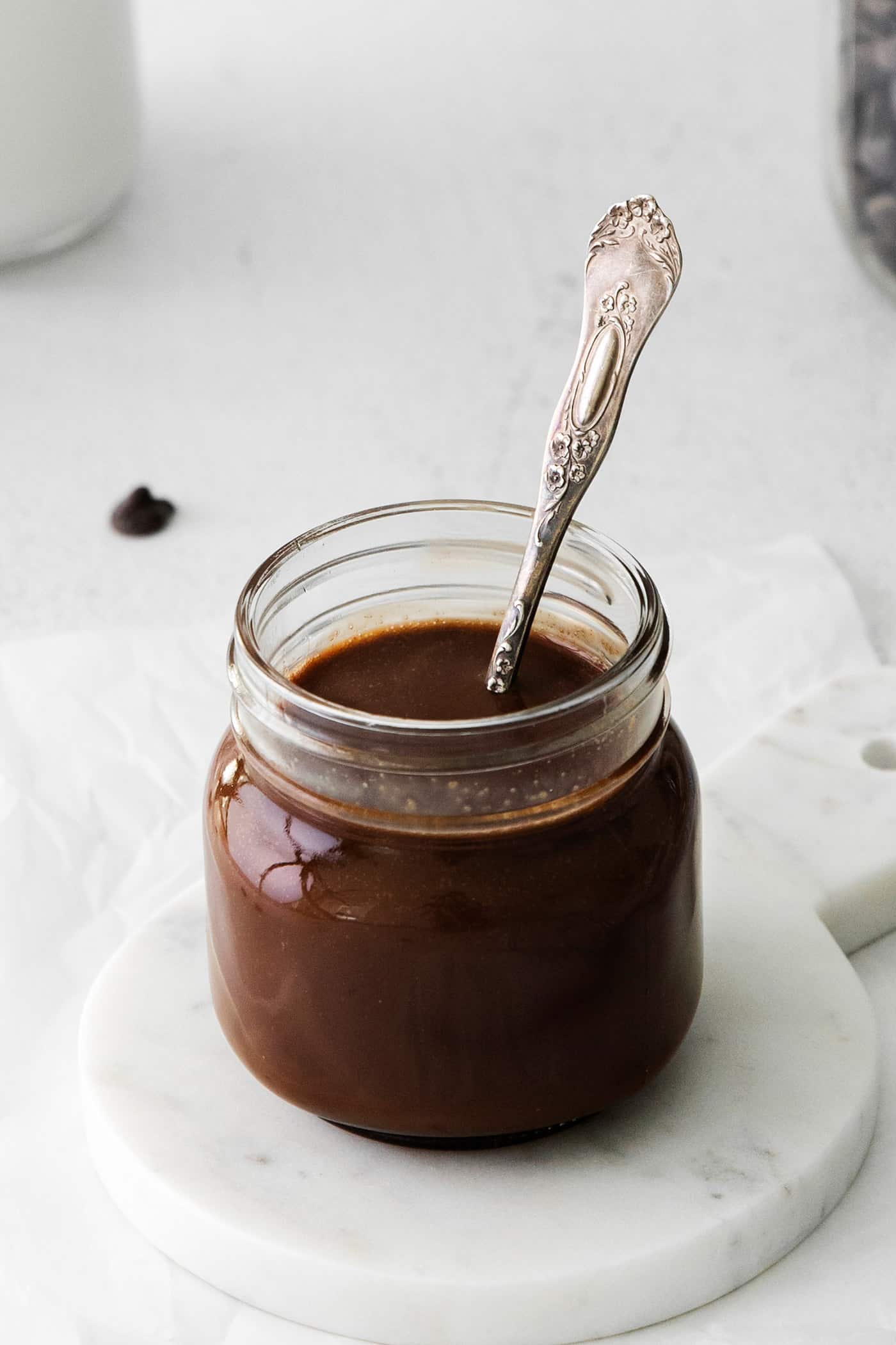 A glass jar of hot fudge sauce