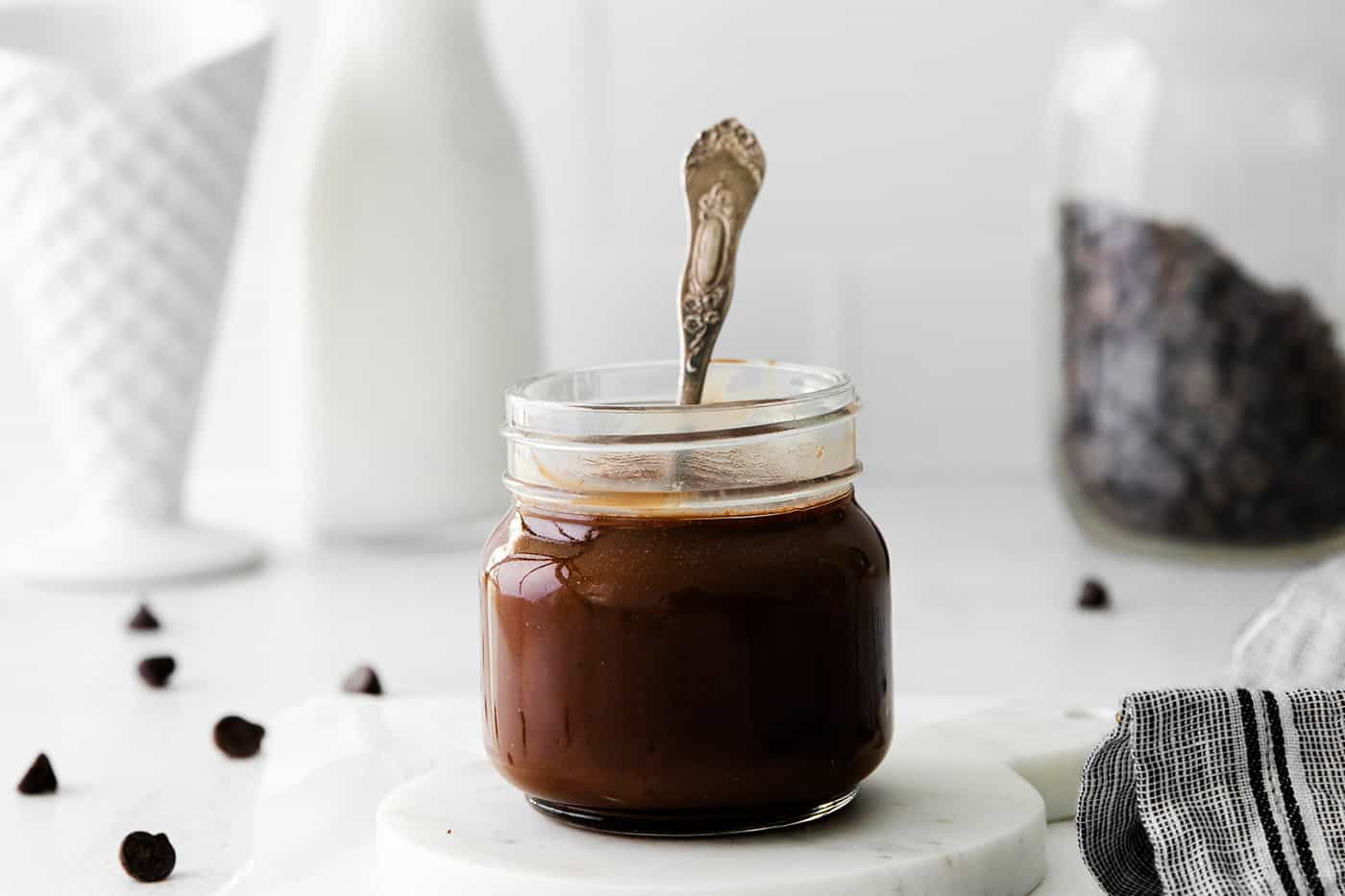 A glass jar of hot fudge sauce