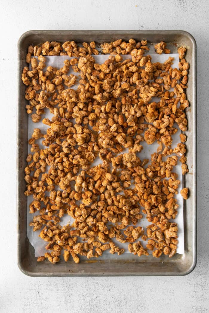 Overhead view of roasted nuts on a baking sheet