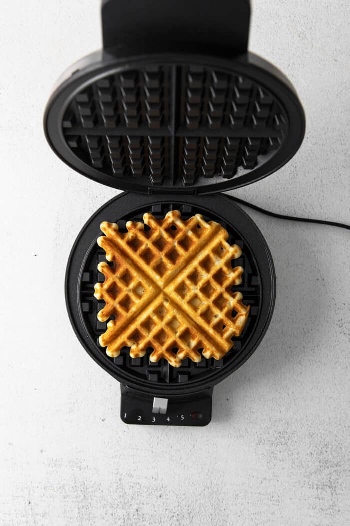 A square buttermilk waffle in a waffle maker