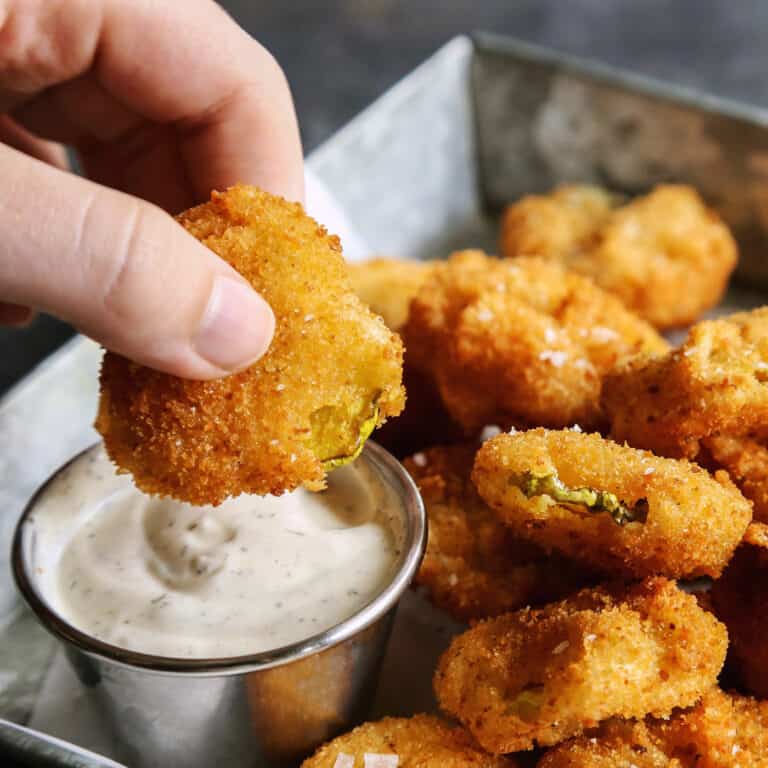 dipping fried pickles into ranch dip