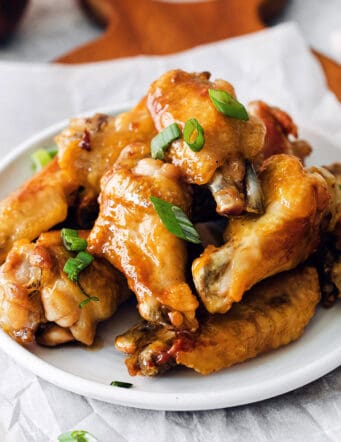 Angled view of a plate of hot honey chicken wings