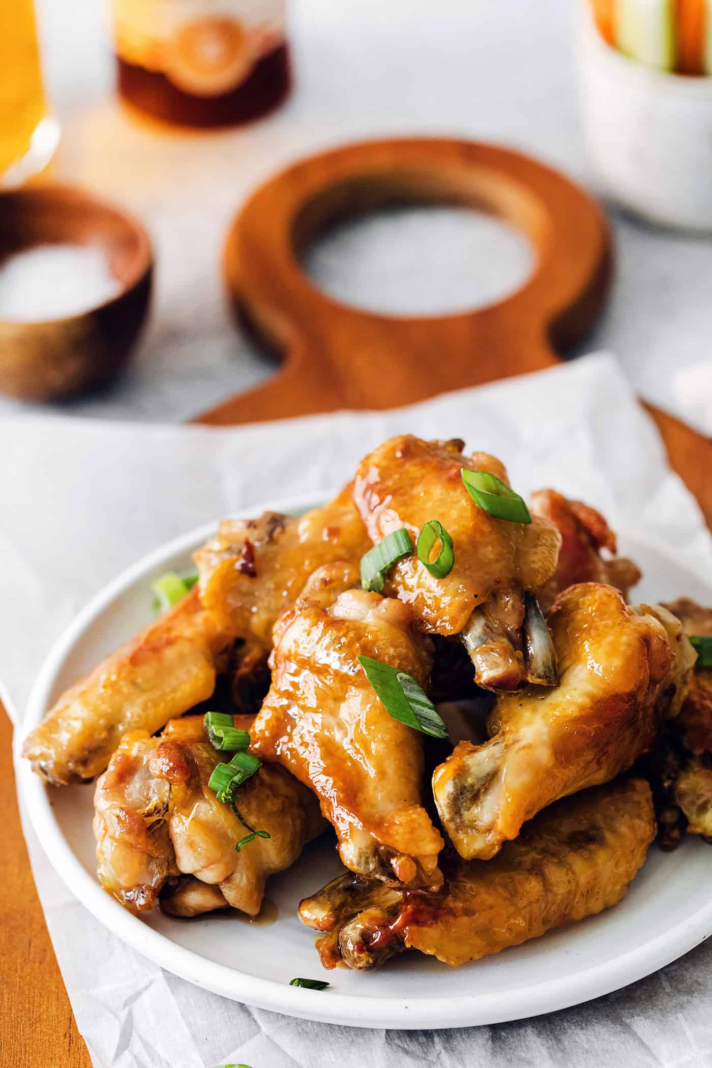 Hot honey crispy baked wings piled on a white plate