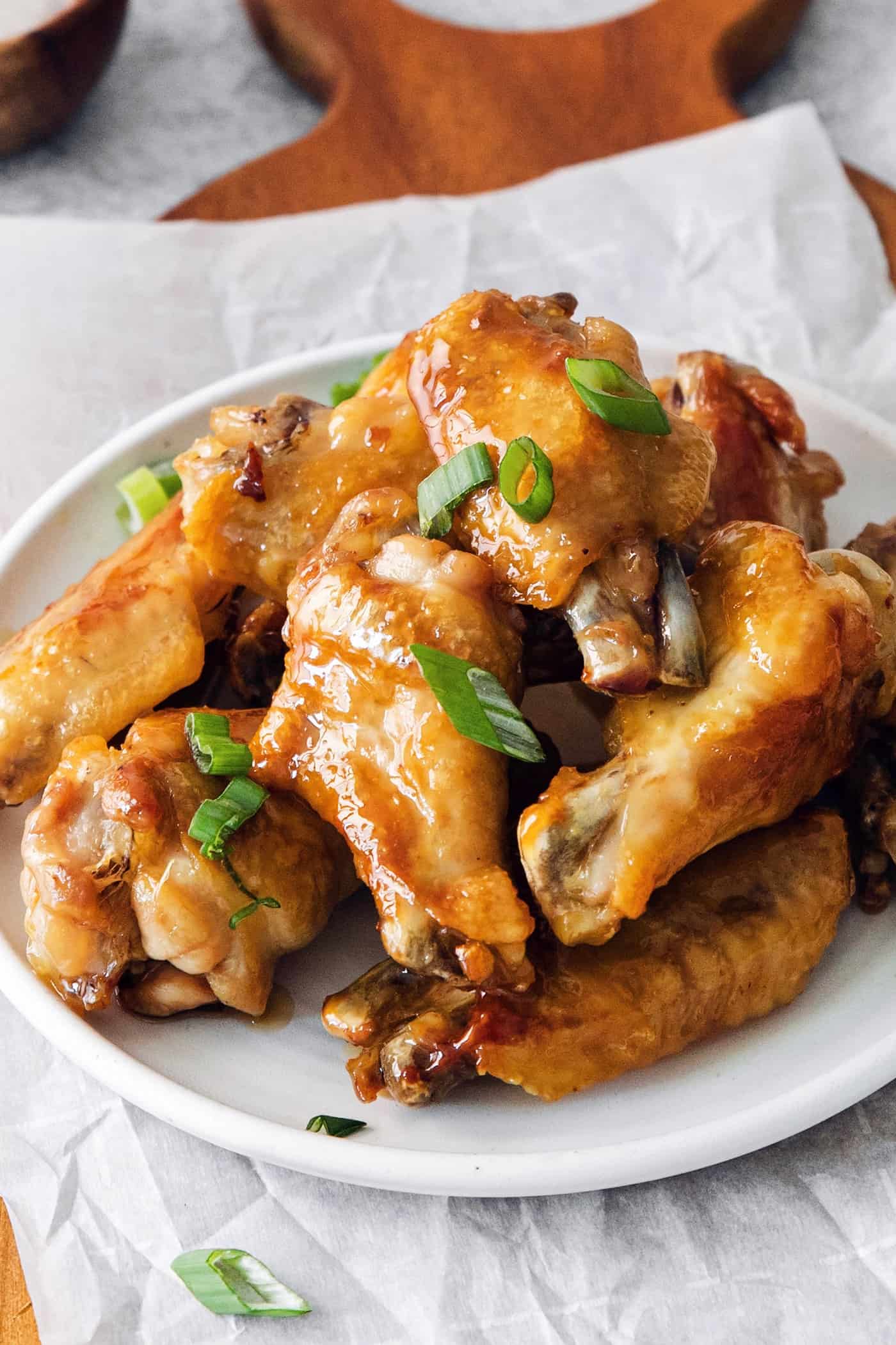 Angled view of a plate of hot honey chicken wings