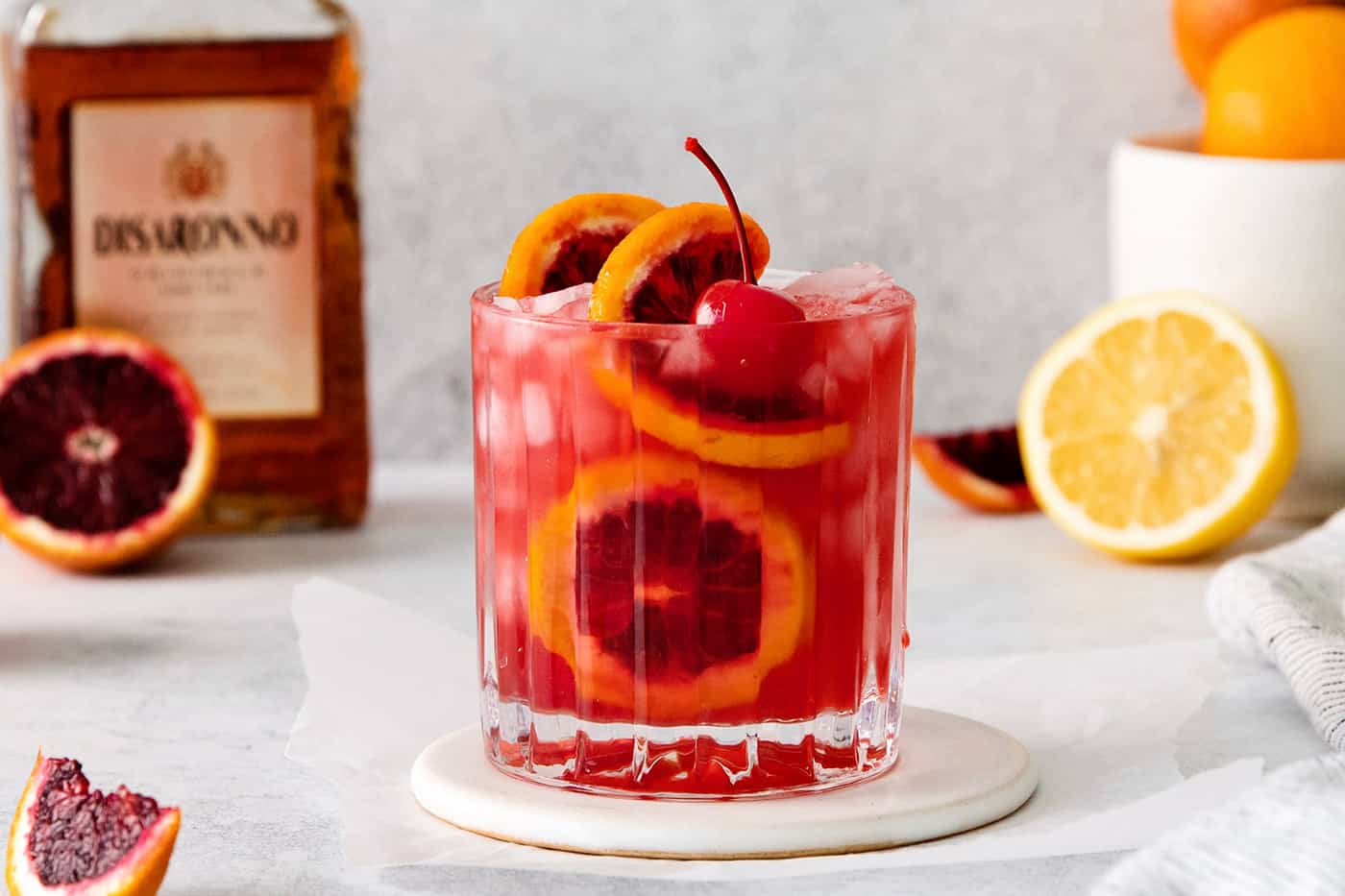 a sour cocktail made with amaretto and blood orange juice