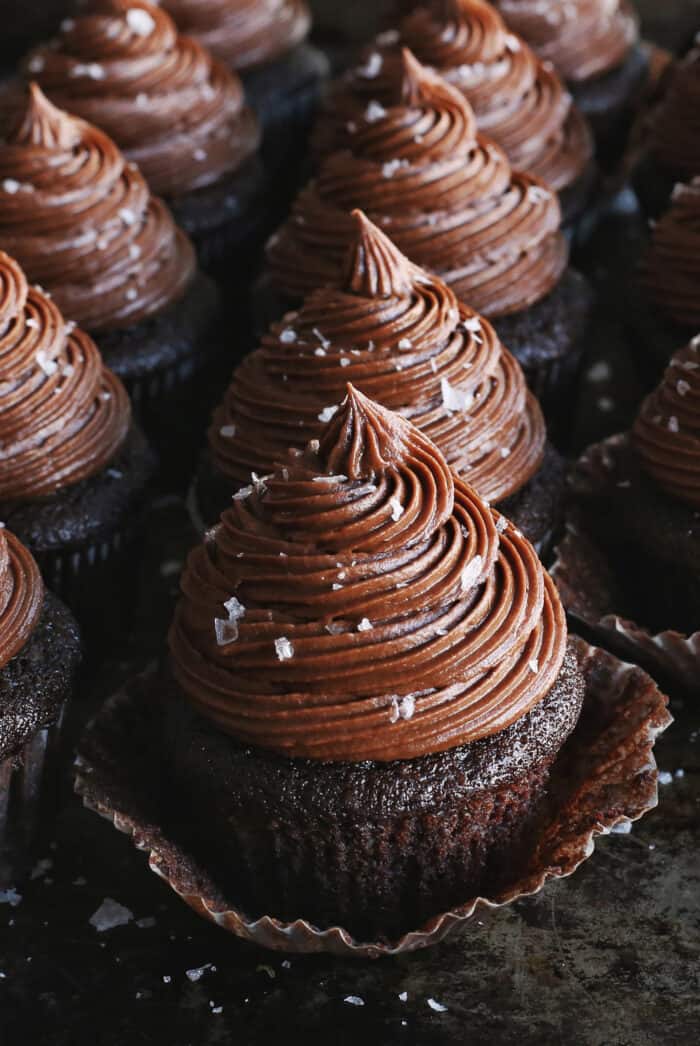 Angled view of chocolate buttercream on chocolate cupcakes