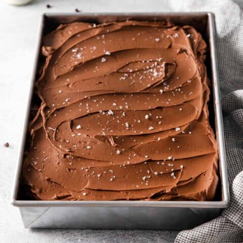 Overhead view of chocolate wacky cake with buttercream frosting in a pan