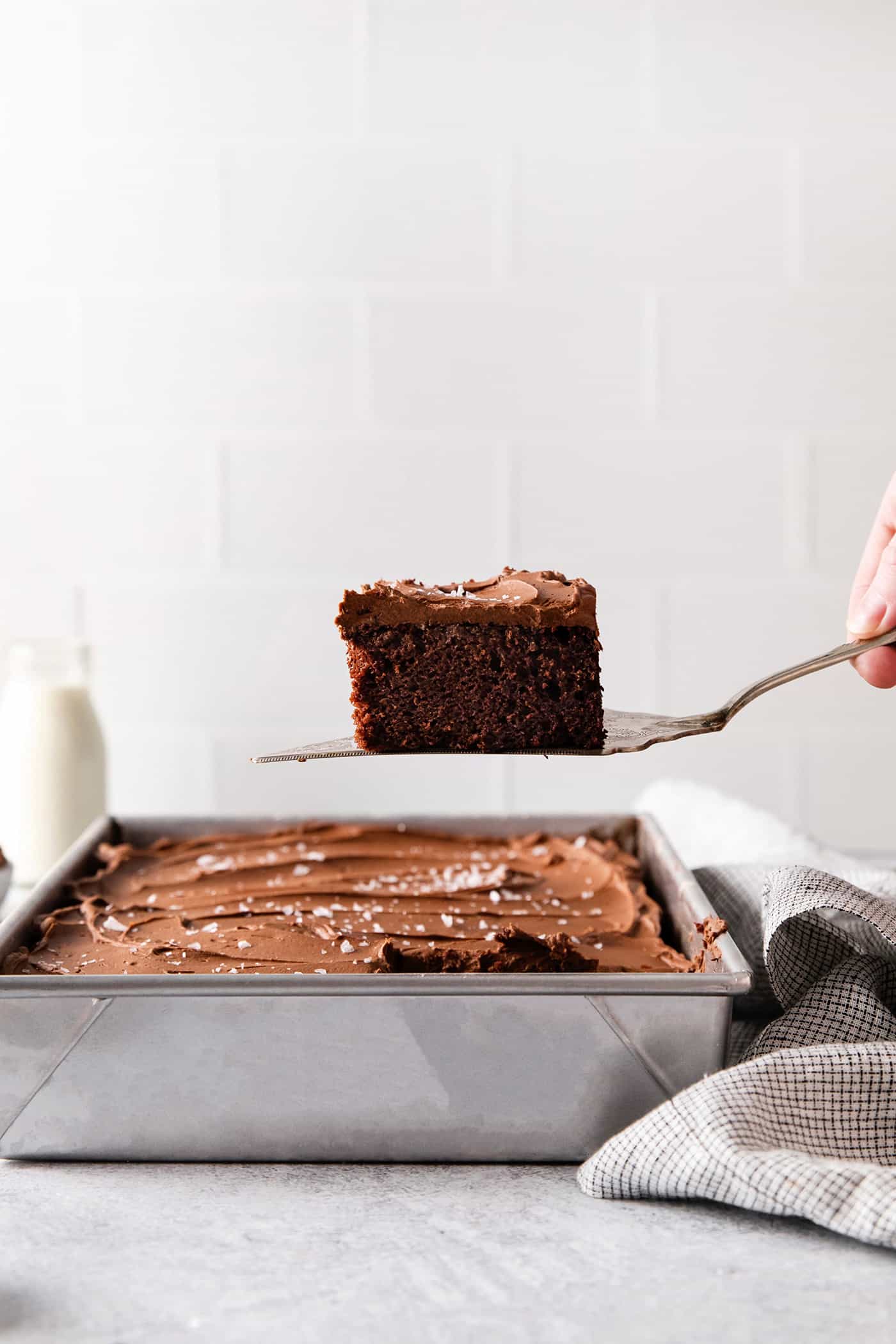 A spatula serving a slice of chocolate wacky cake