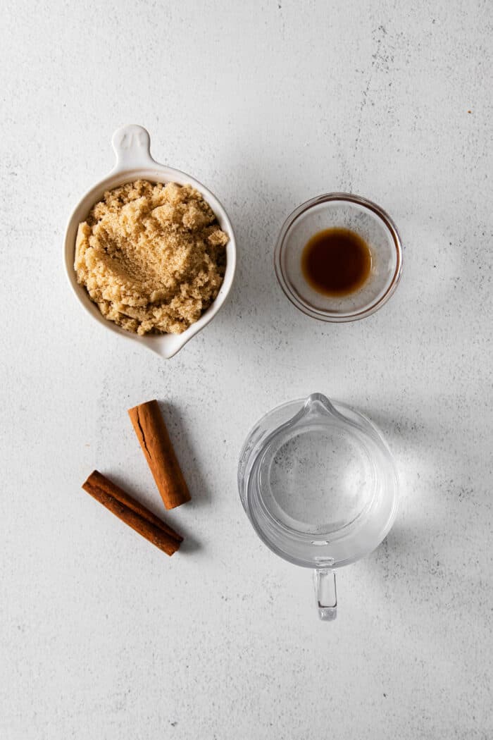 ingredients to make a cinnamon syrup: water, brown sugar, cinnamon sticks, and vanilla extract