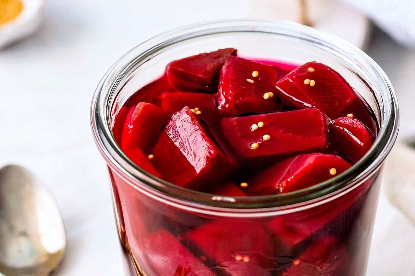 close-up photo of cubed pickled beets in a jar