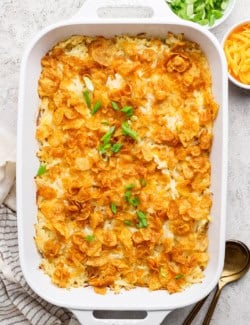 Overhead view of cheesy hashbrown casserole in baking dish