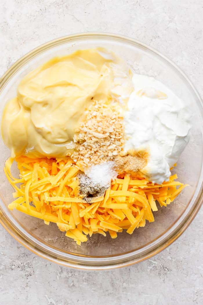Ingredients for cheesy hashbrown casserole sauce in bowl before stirring