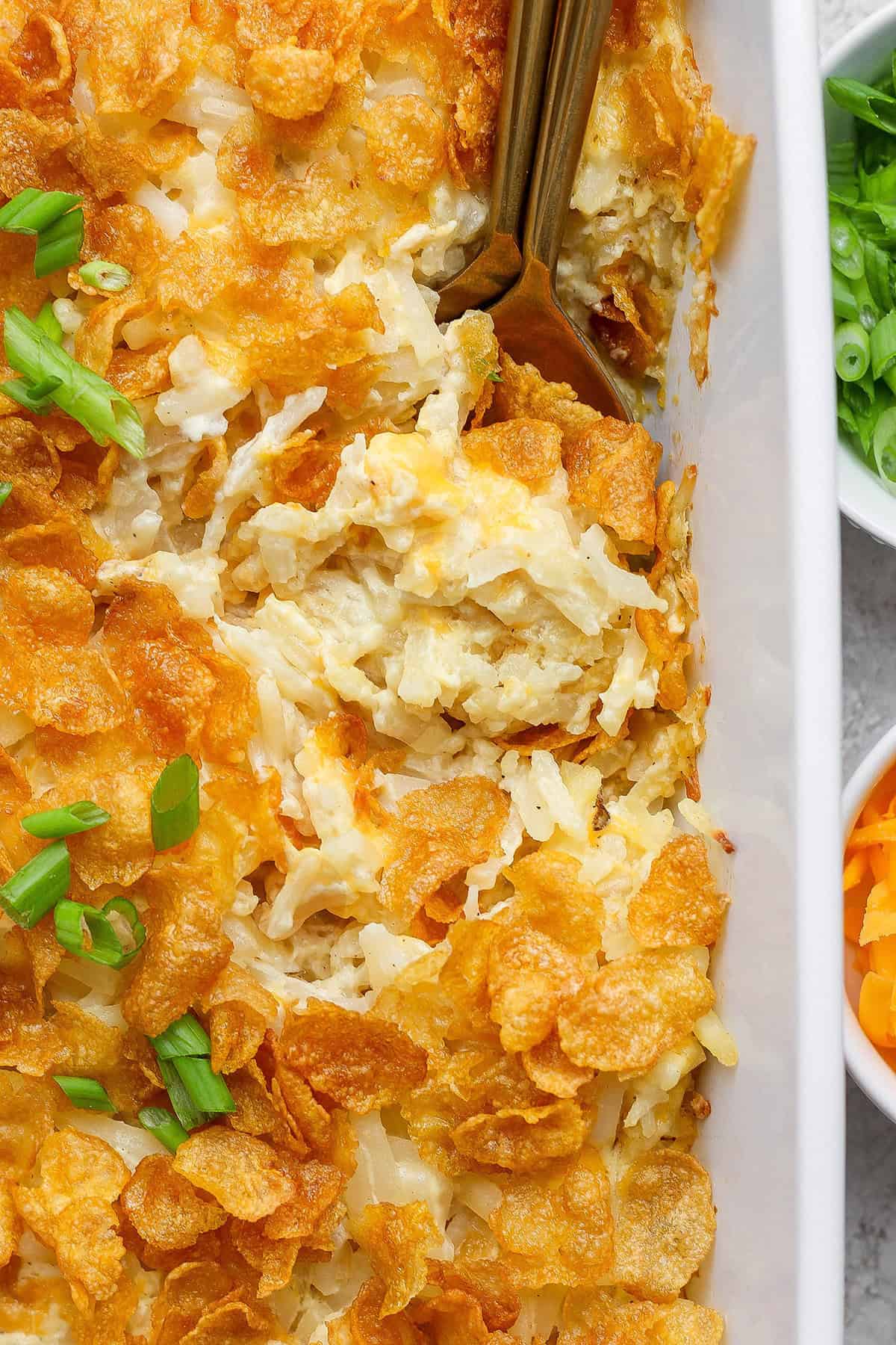 Overhead view of cheesy hashbrown casserole in baking dish