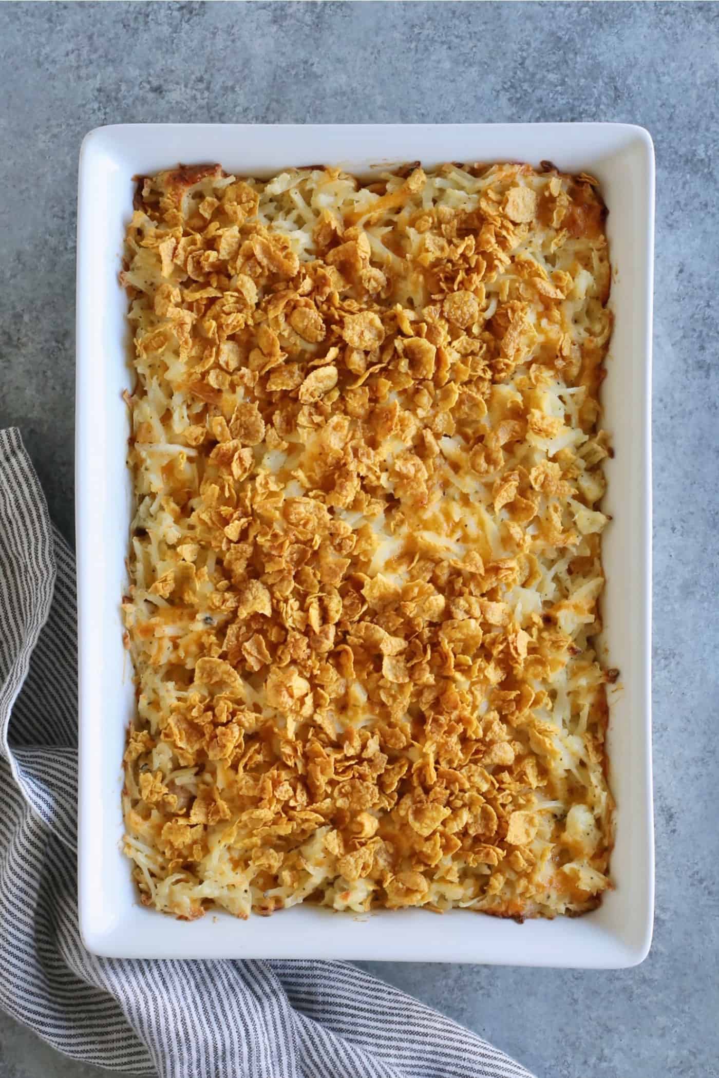 cheesy hashbrown casserole baked with crushed cornflakes topping