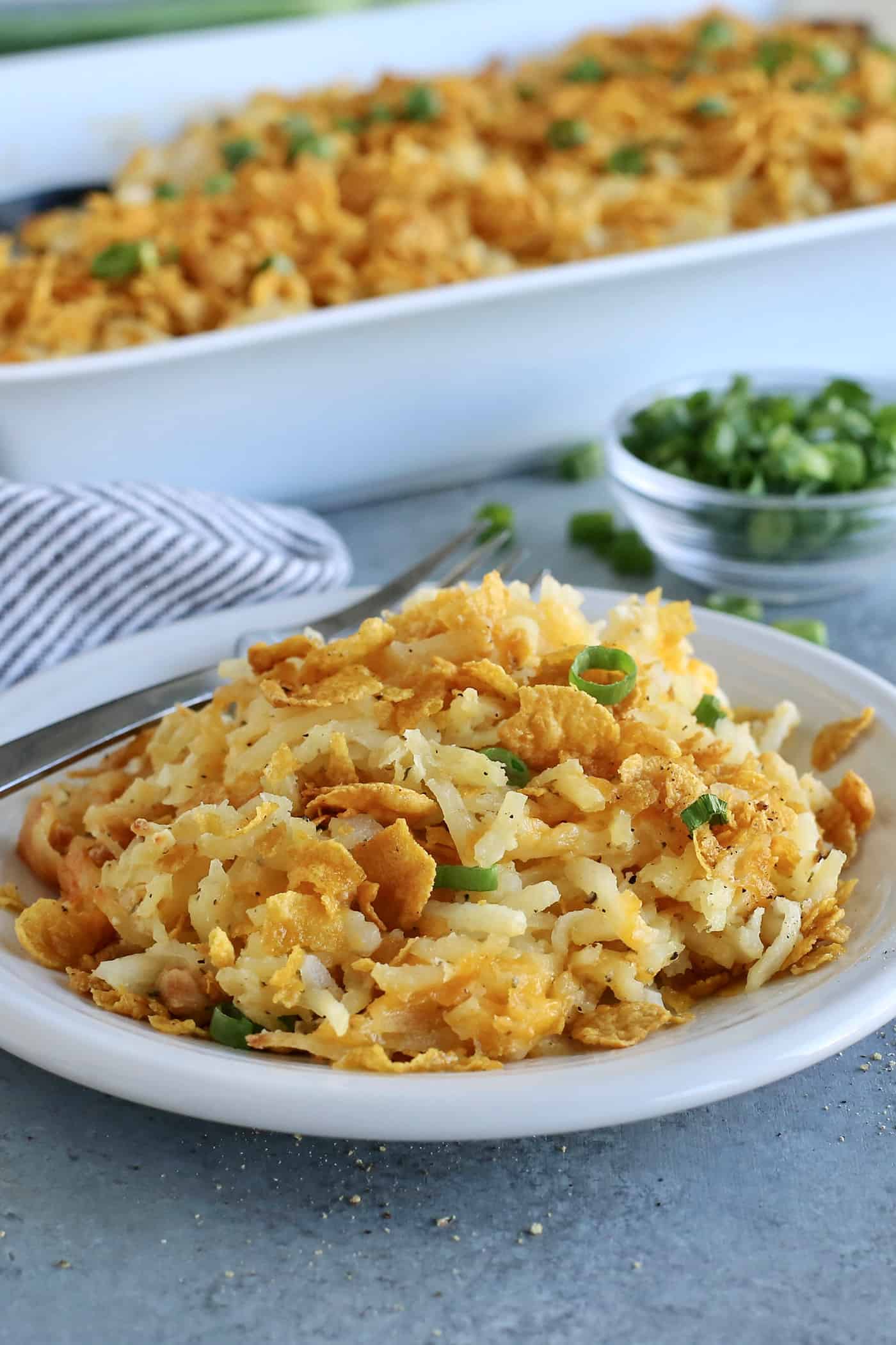 an individual serving of hashbrown casserole on a white plate