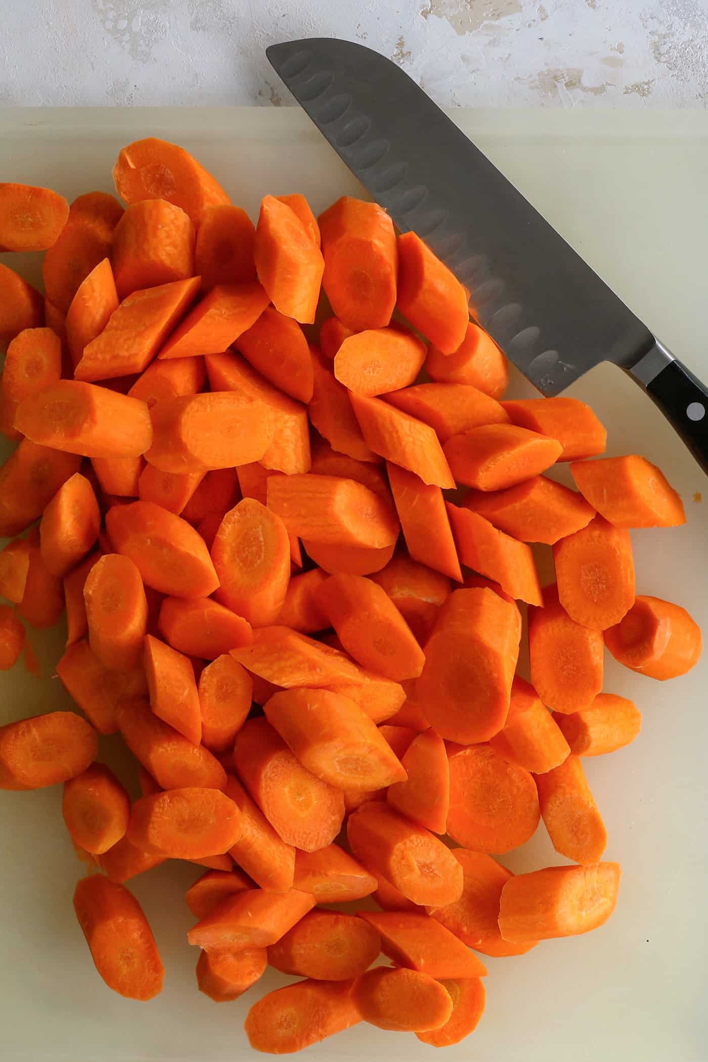 cutting carrots on a cutting board