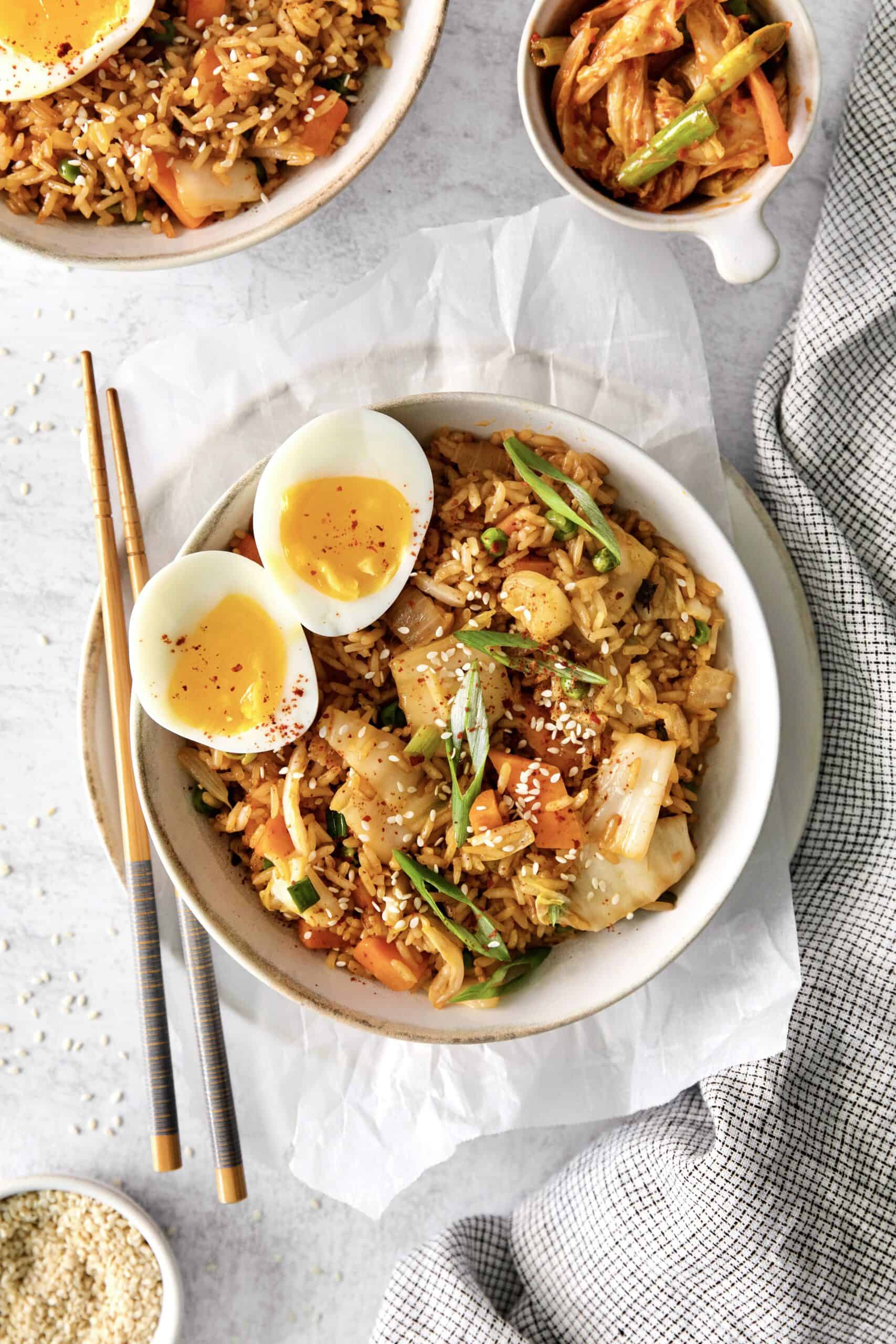 A bowl of kimchi fried rice with a soft boiled egg