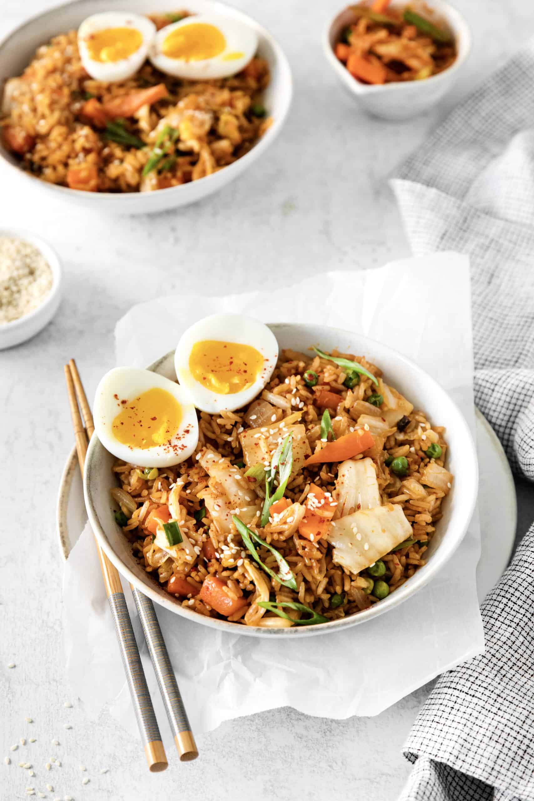 Angled view of a bowl of Kimchi fried rice with another bowl in the background