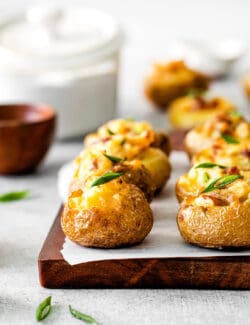 Mini baked potatoes on a cutting board