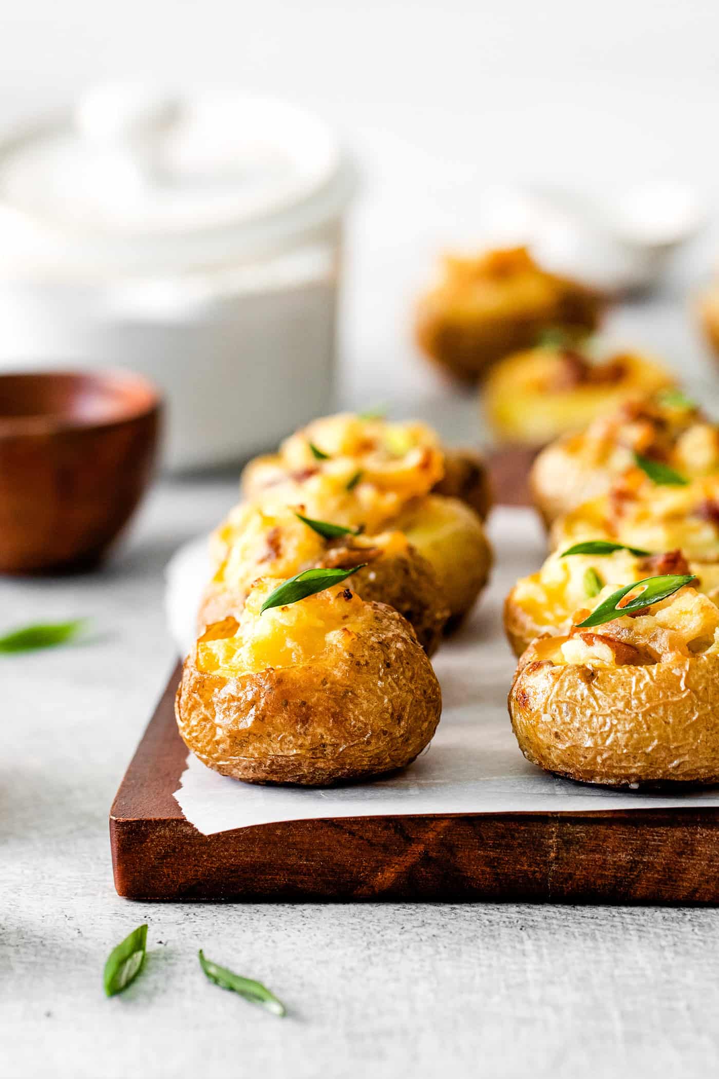 Mini baked potatoes on a cutting board