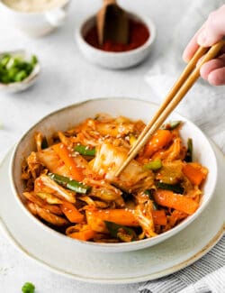 Chopsticks in a bowl of quick kimchi