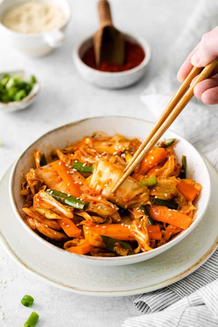 Chopsticks in a bowl of quick kimchi