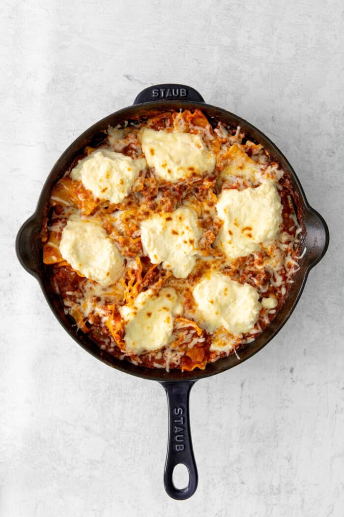 Melted cheese on top of a skillet lasagna