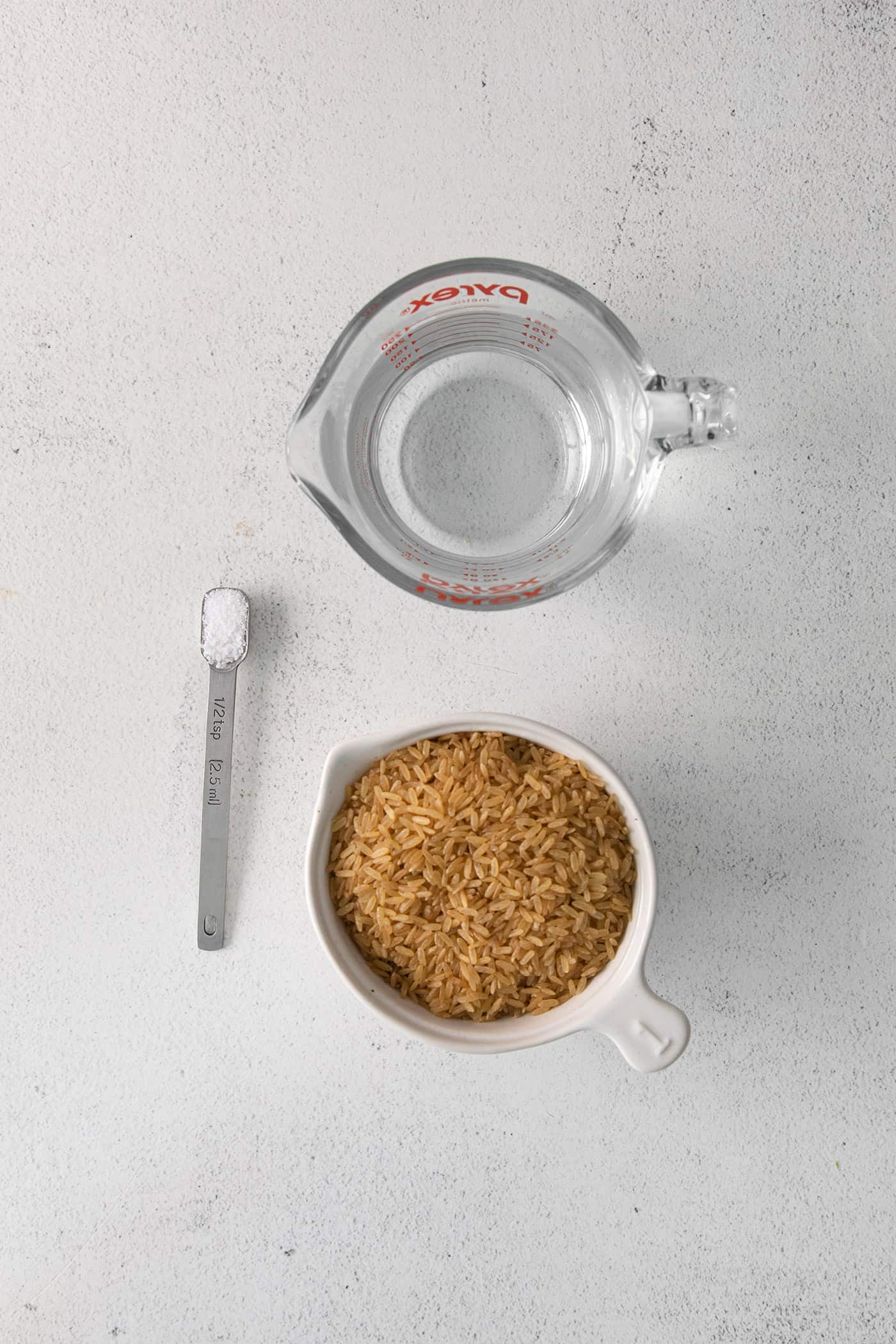 Brown s sugar in a bowl next to water