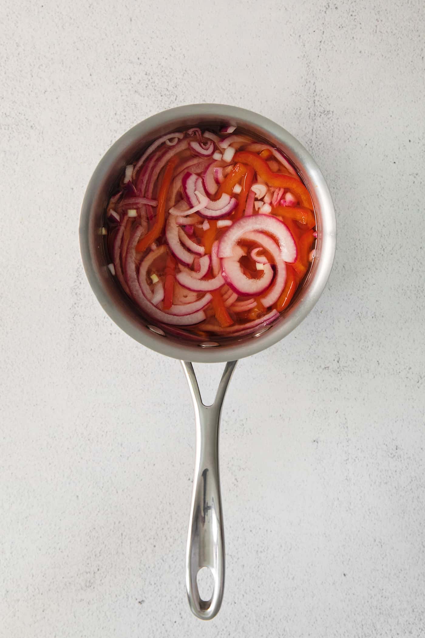 Slices of onion and pepper in pickling juice