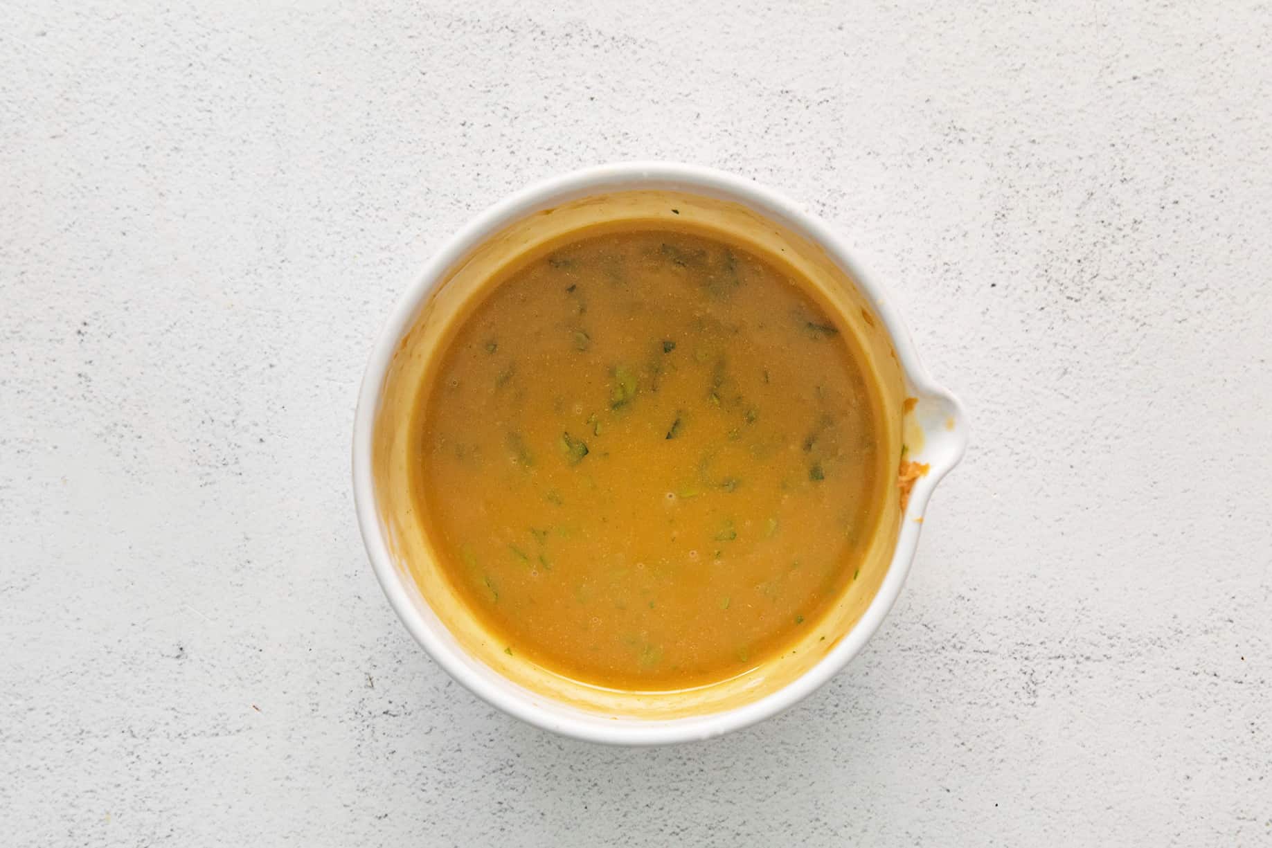 peanut lime dressing in a white bowl