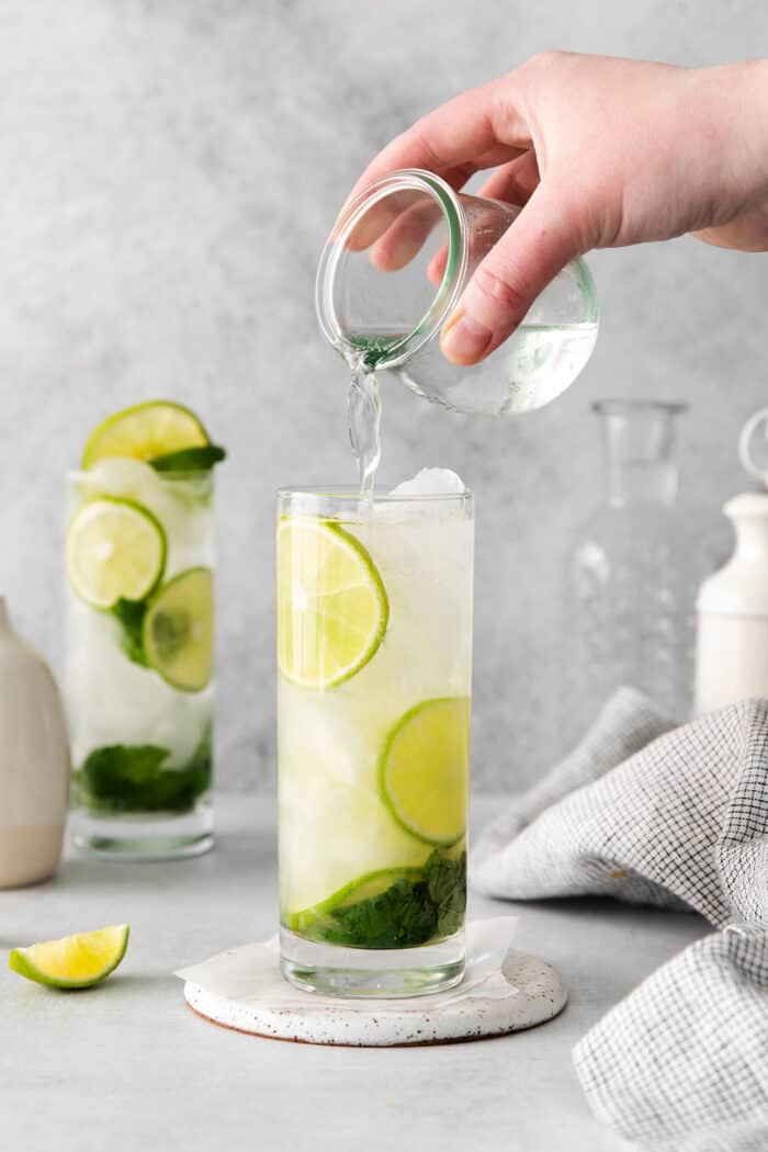 Soda being added to a tequila mojito