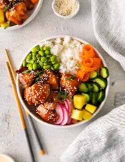 Overhead view of teriyaki chicken poke bowl topped with fresh veggies