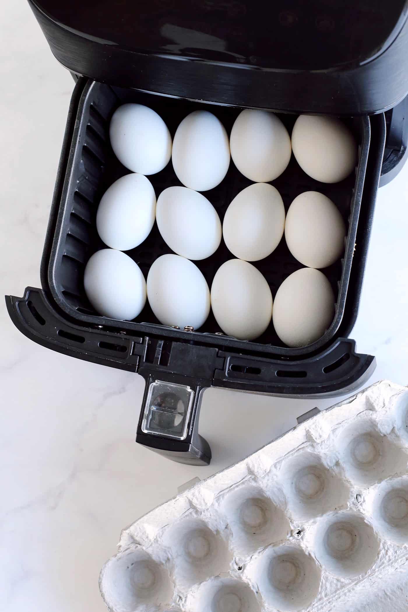 A dozen eggs in an air fryer basket