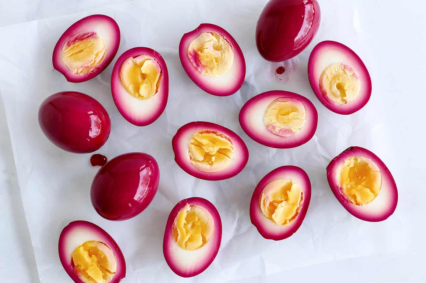 Overhead view of beet pickled eggs cut in half