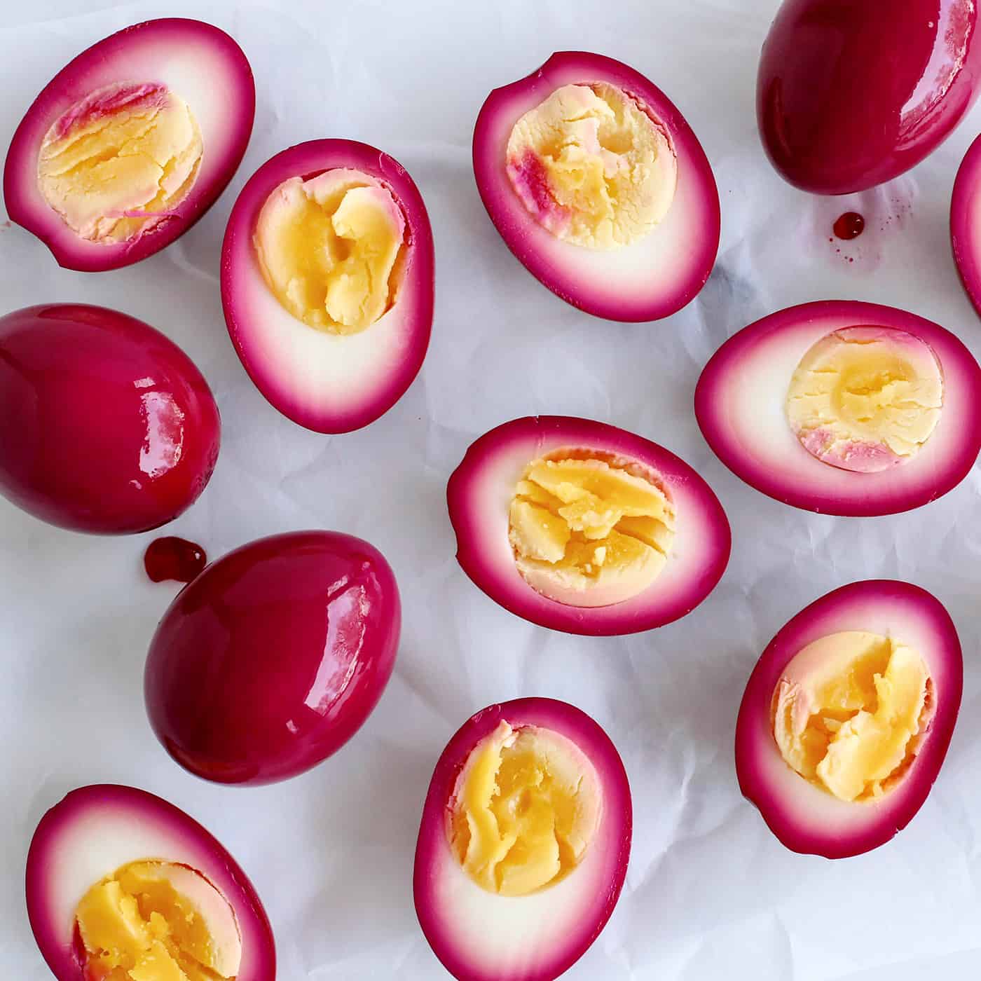 Overhead view of beet pickled eggs cut in half