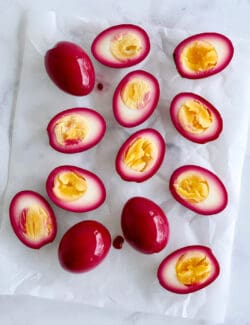 Overhead view of beet pickled eggs cut in half