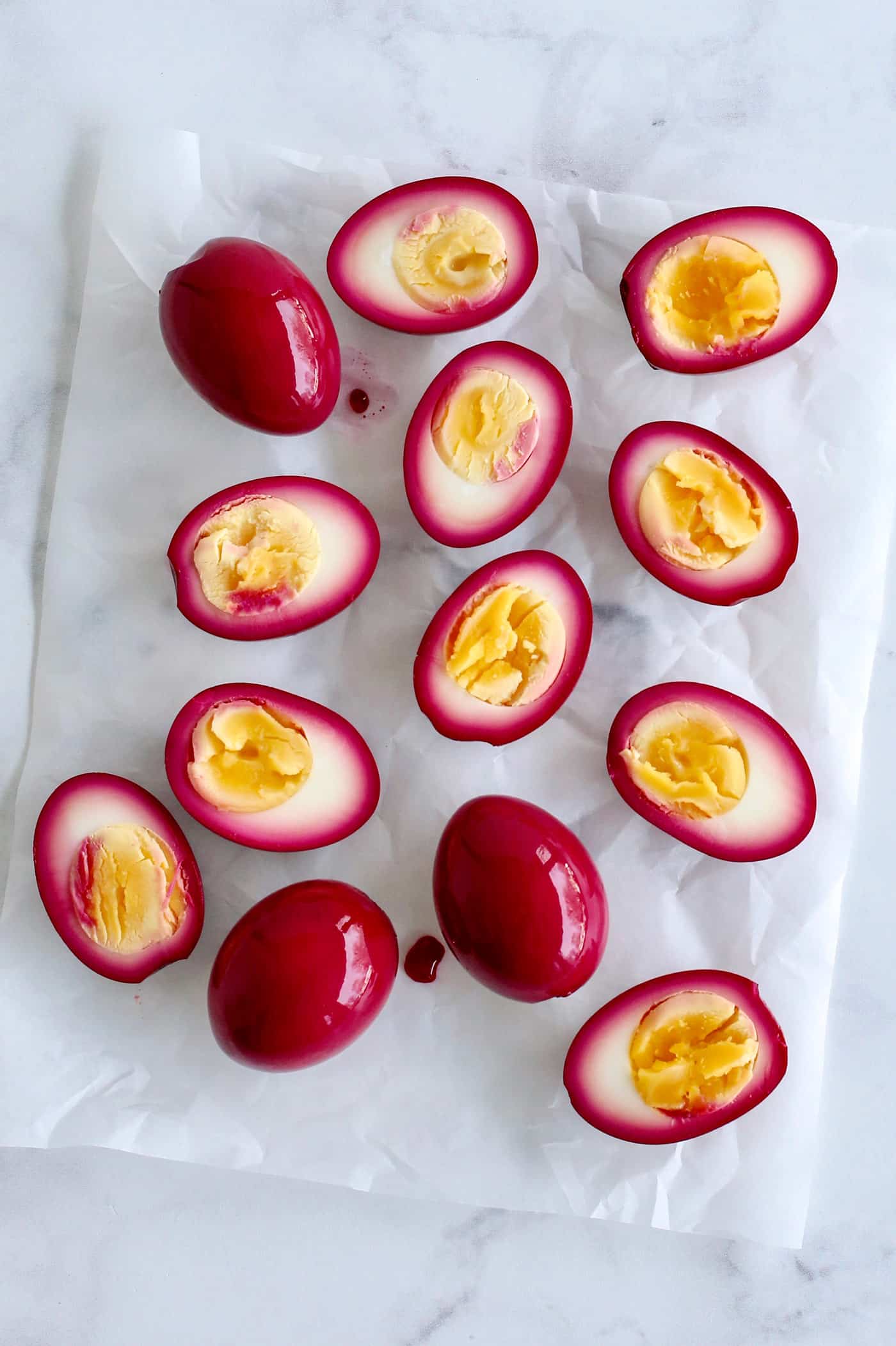 Overhead view of beet pickled eggs cut in half