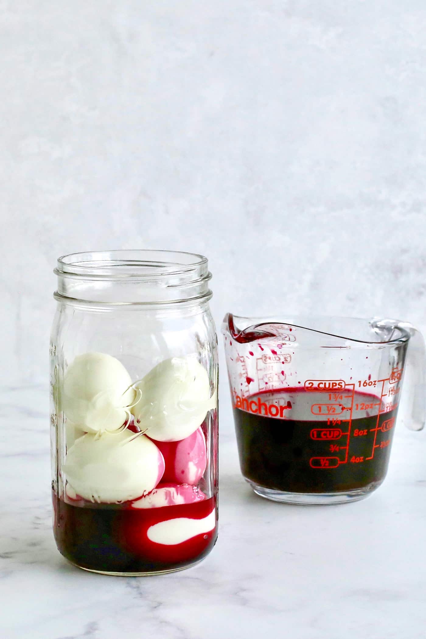 A jar of hardboiled eggs with beet juice