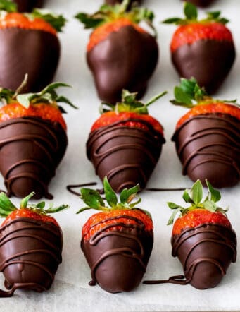 Overhead view of chocolate covered strawberries on a baking sheet