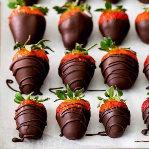 Overhead view of chocolate covered strawberries on a baking sheet