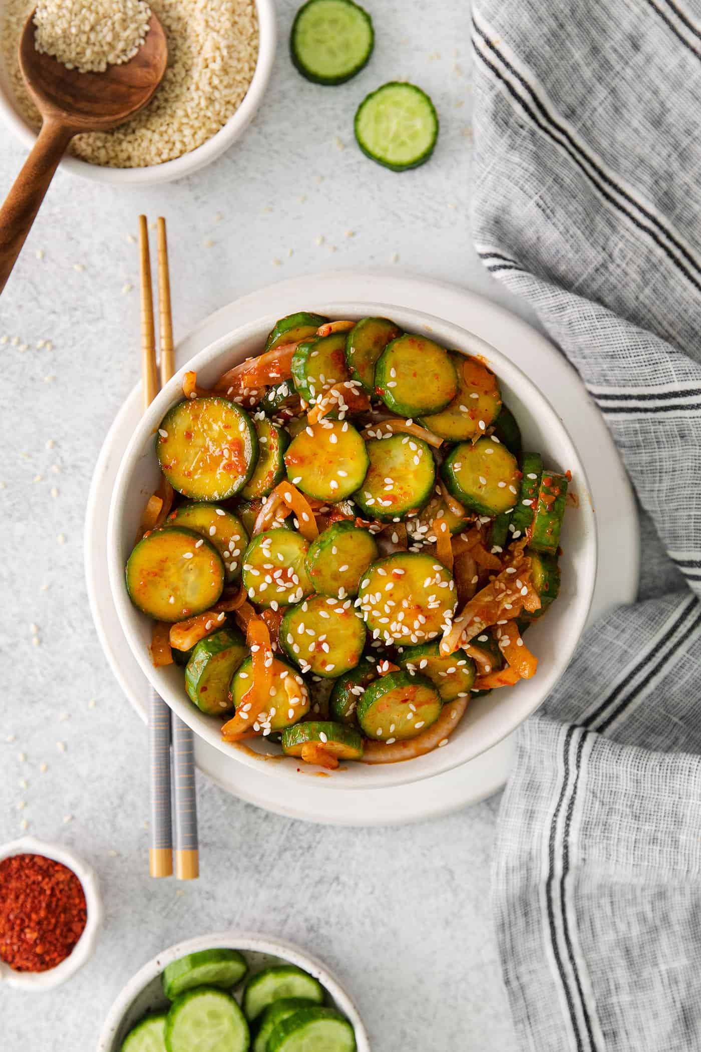 Overhead view of spicy cucumber salad in a white bowl