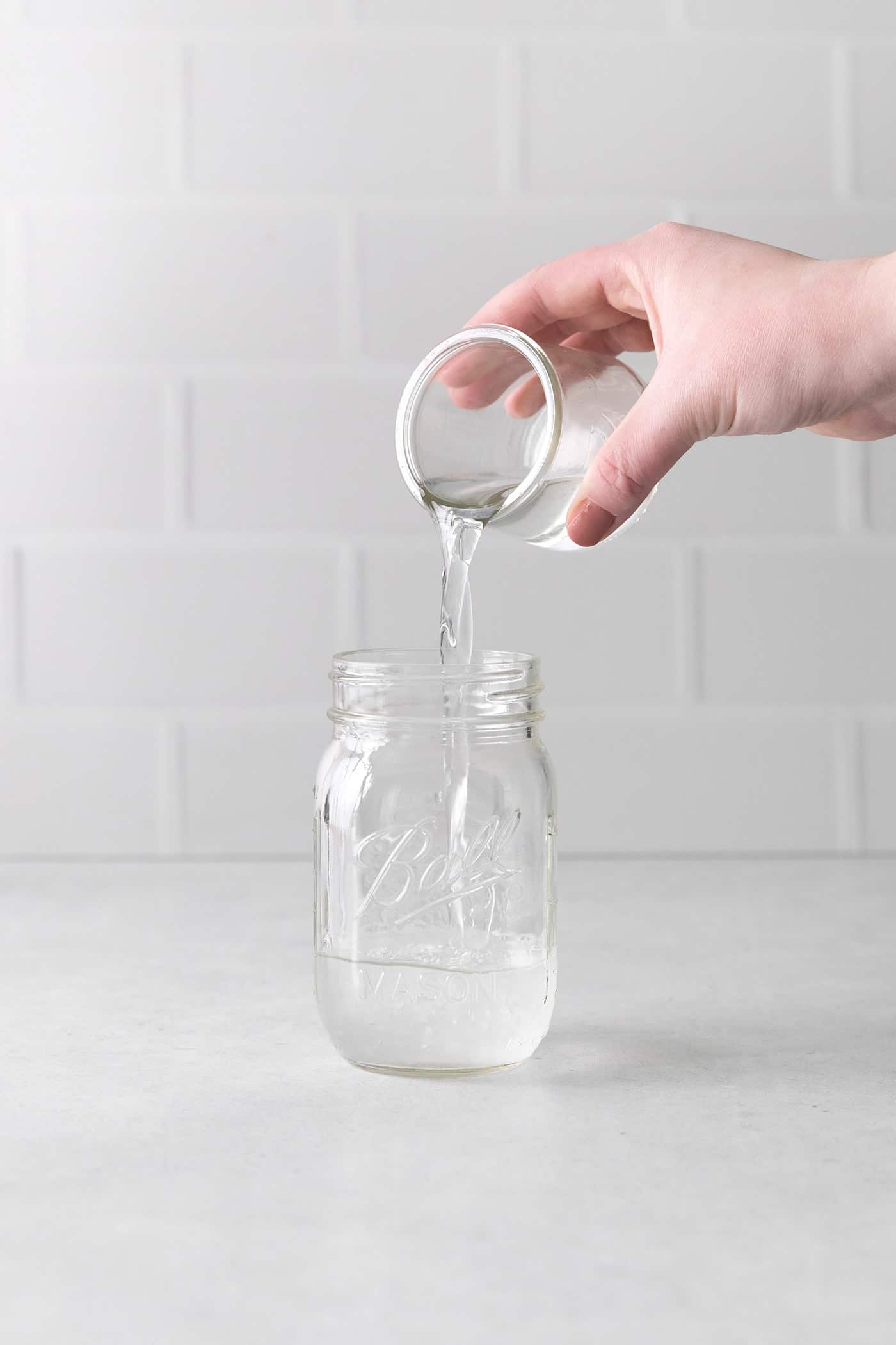 pouring Cointreau into a jar