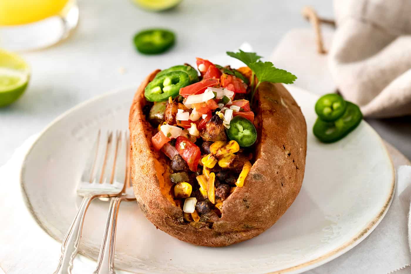 A taco stuffed sweet potato on a white plate