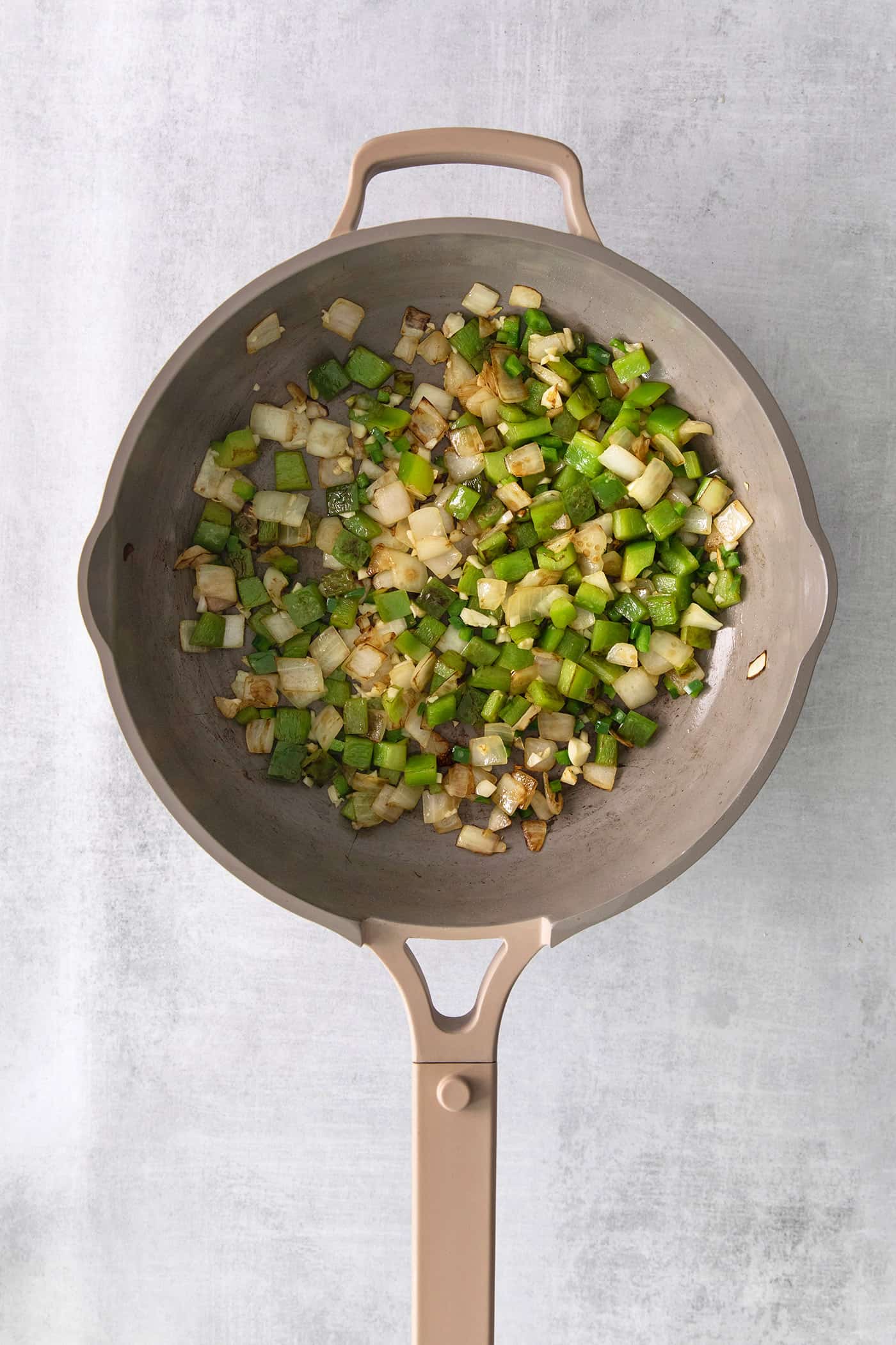 Peppers and onions sauteed in a skillet