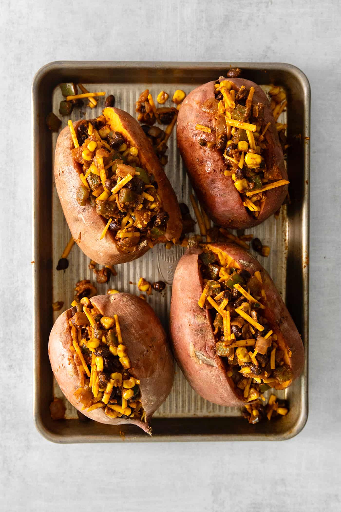 Sweet potatoes with taco filling on a baking sheet
